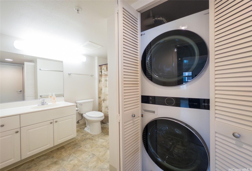 Newer toilet and washer/dryer with an easily accessible cutout for the Hot/Cold water shutoff valves.