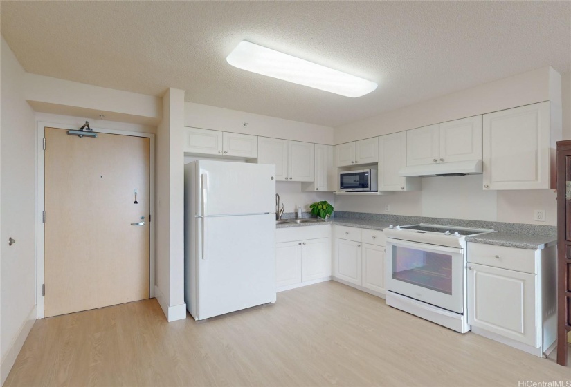 Efficient kitchen with a newer refrigerator & kitchen faucet.  Note: The new 50-gallon water heater is in the hallway, next to the unit’s front entrance.