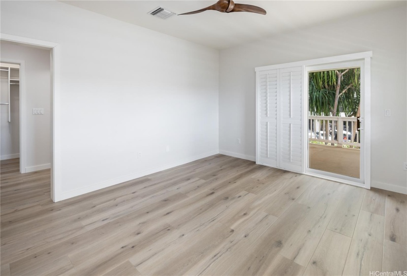 Primary bedroom with new high-end vinyl flooring and large lanai