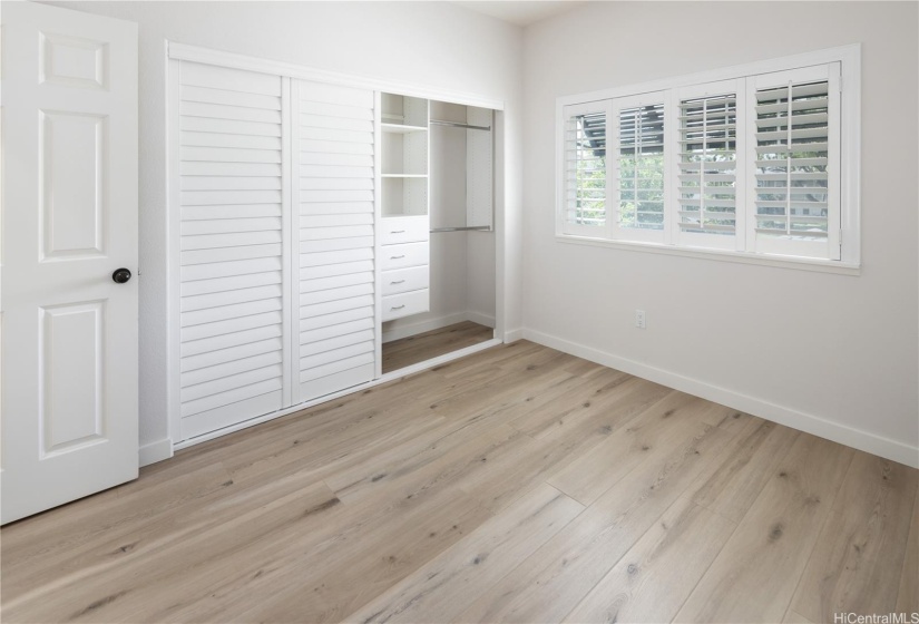 Another bedroom upstairs with plantation shutters