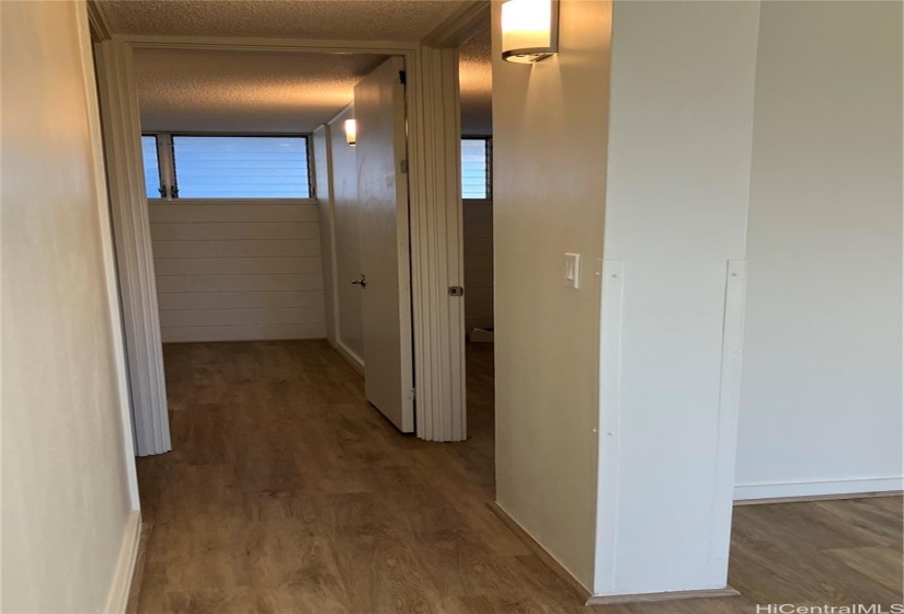 Hallway to two bedrooms and full bathroom.