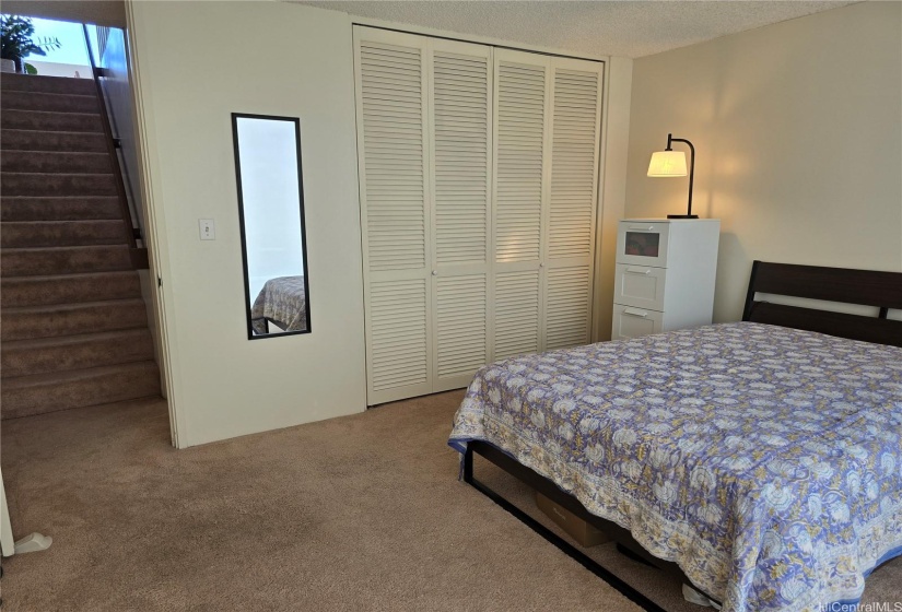 Another angle of the bedroom leading upstairs to the main level.