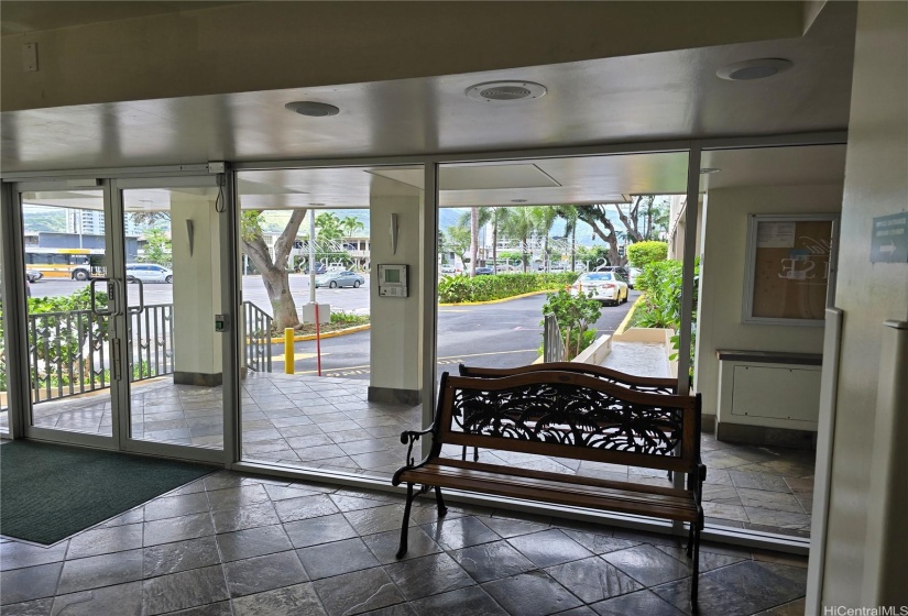 Main entrance into the secured building. Intercom visible on the outside wall.