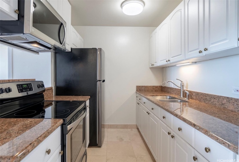 Granite countertops, stainless steel appliances, tile flooring.