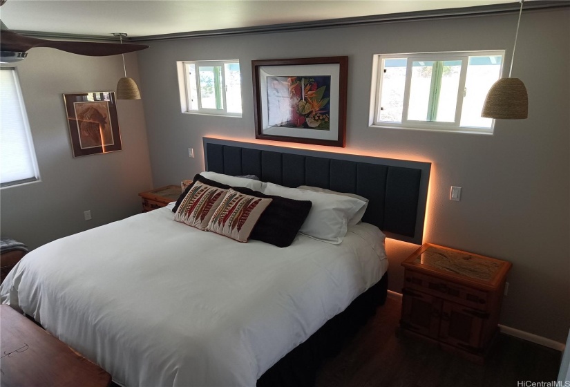 Master bedroom with illuminated back lit headboard.