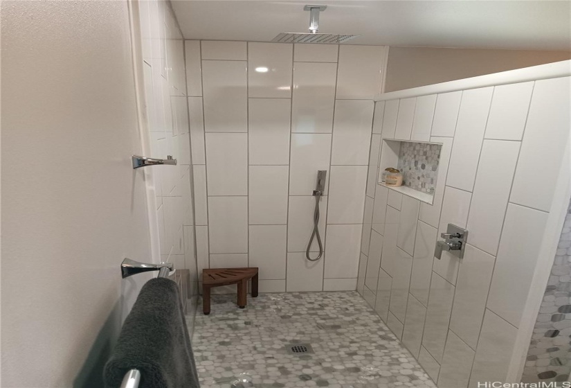 Image of an all white walk in shower.