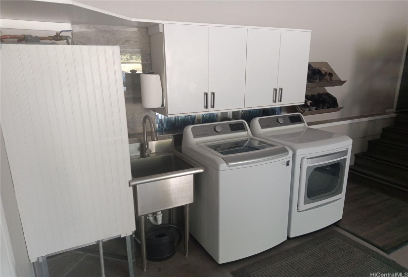 Washer / dryer and cabinets above.