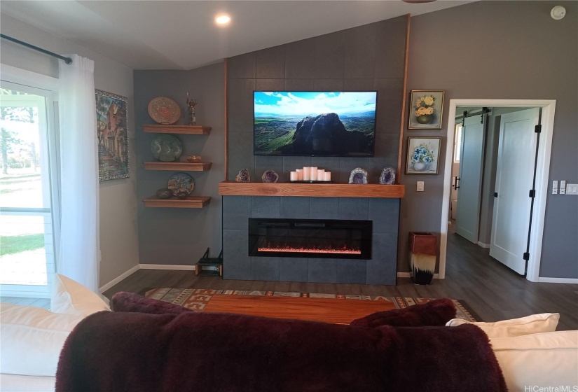 Close up of tiled TV wall and fireplace.