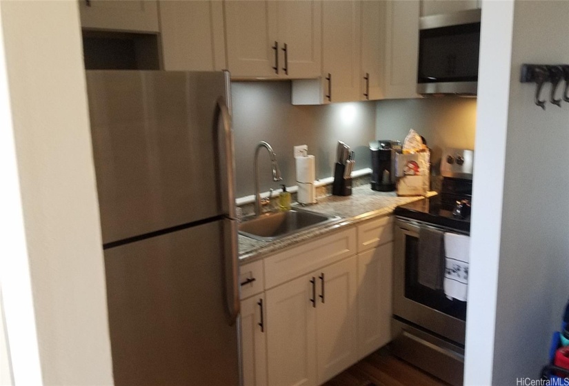 Kitchen includes a full size stove, refrigerator and sink.