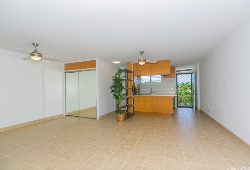 A look from the lanai towards the partially hidden bathroom entrance, kitchen and front door.