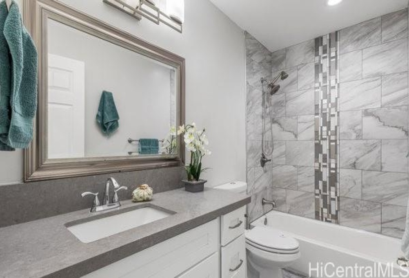 beautifully renovated hallway bathroom with tub.