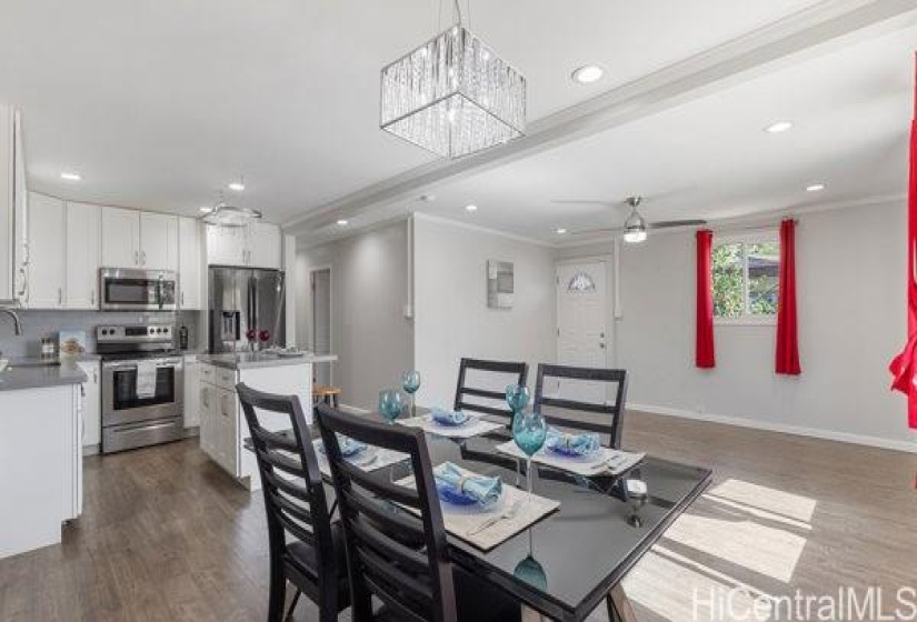 dining area with elegant chandelier. The sellers would like the dining table with chairs to stay.