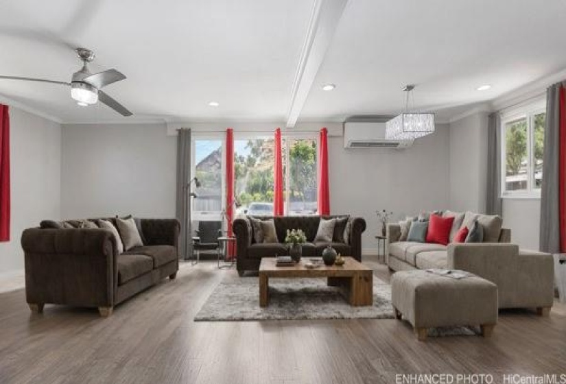 Enhanced photo with virtual staging of living room furniture. Note the split AC unit.