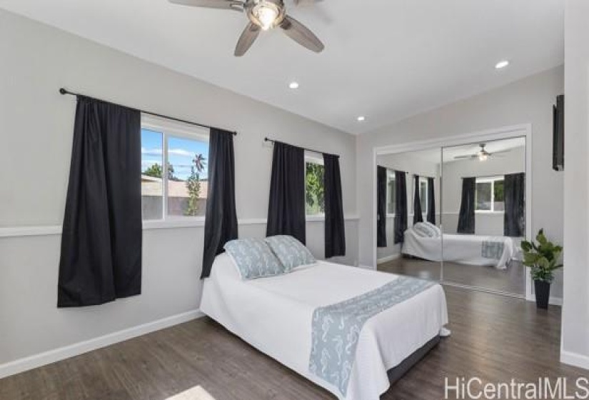 Note the ceiling fan, recessed lighting and large mirrored closet.