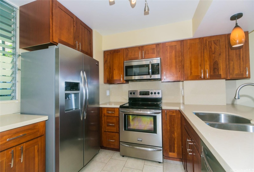 Remodeled kitchen with stainless appliances, large refrigerator with ice maker