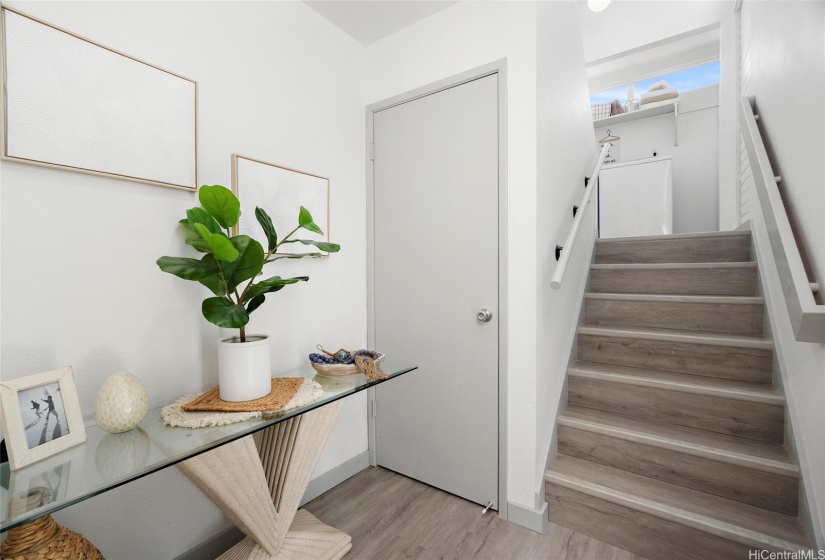 Sweet entry way.  To the left, not pictured here is the kitchen/living. To the right, split level living leading to your private spaces.  The door pictured here is a large under stairwell storage closet.