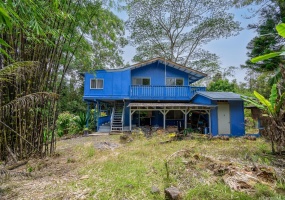 Stairs leads to separate entrance of second floor front door entrance and outdoor storage shed.