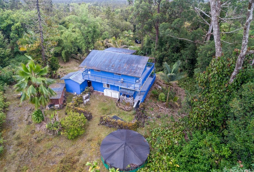 Water catchment located in backyard and 2 outdoor storage sheds.