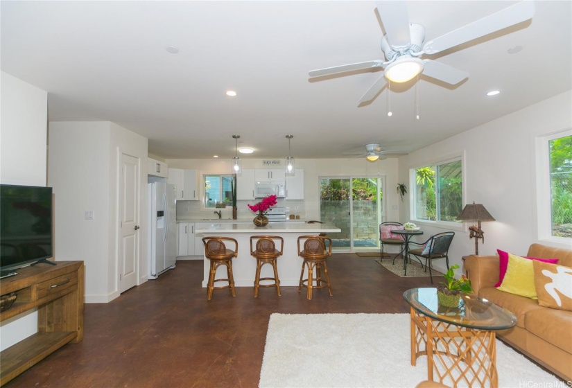 Downstairs living room looking into open kitchen