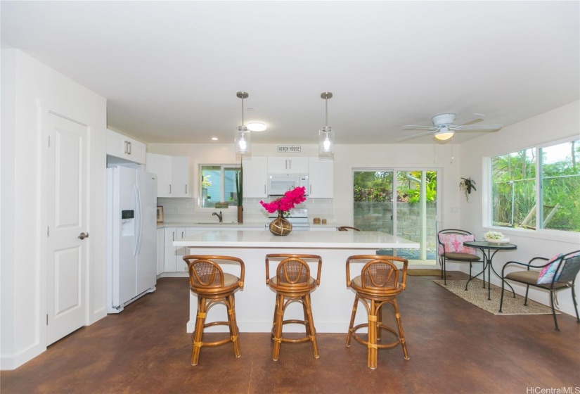 Downstairs kitchen with cement floors - Sliding glass doors go out to washer and dryer