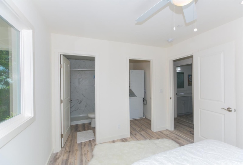 Up Stairs Primary bedroom looking at full bath on left, walk-in closet and hallway to other 2 bedrooms and full bath