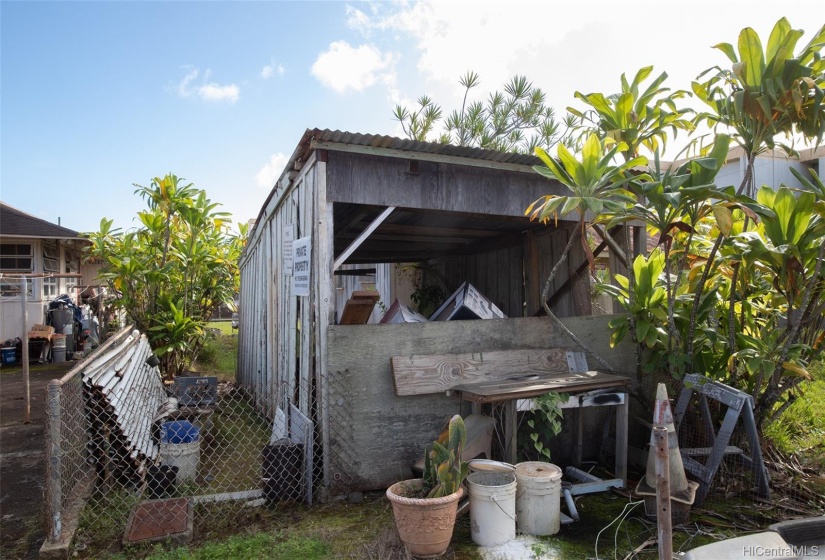 One car carport is built right up to the property line.  Owner has not removed it so that its location may be 'grandfathered' in.  This is located on the unofficial driveway side of the property.