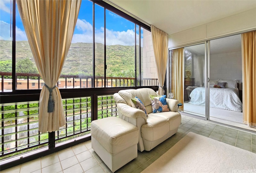 Step out onto the covered private lanai to enjoy the cool breeze and take in the serene views of the garden and mountains, framed by mature trees