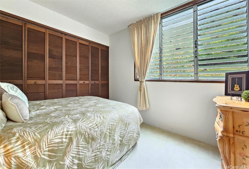 Overlooking nice garden view from comfortable 2nd bedroom! Enjoy the cool breezes!