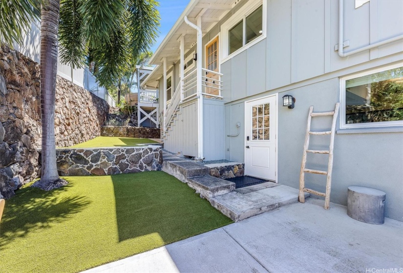 Side yard and entrance to the lower level with separate entry