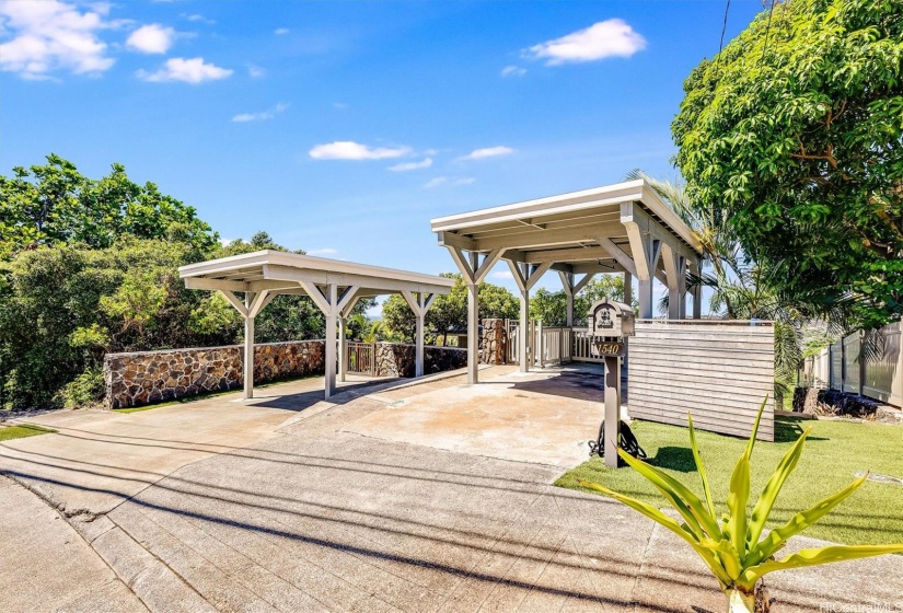 Wide driveway apron with 2 covered carport parking