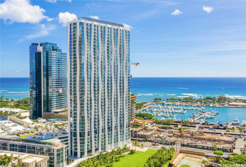 Ko'ula Building soars toward Kewalo Basin Harbor and Ala Moana Beach Park.