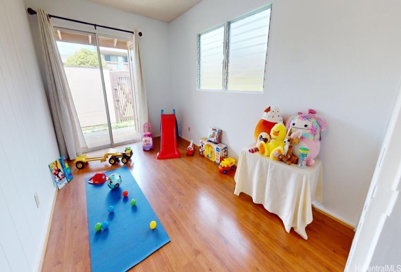 Second bedroom next to primary bedroom with sliding door going outside to the patio