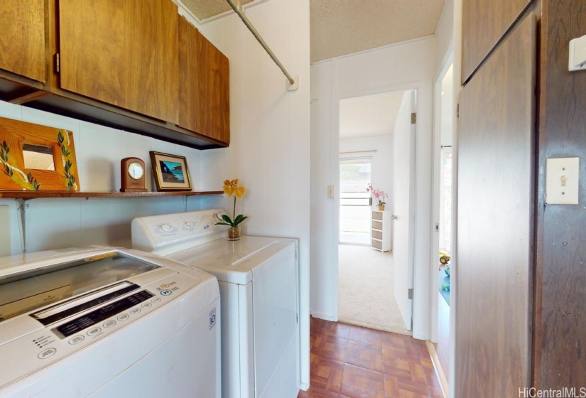 Washer and dryer in unit with shelves to keep laundry products