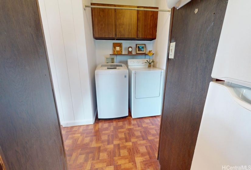 Hallway with washer and dryer on one side and kitchen on the other side