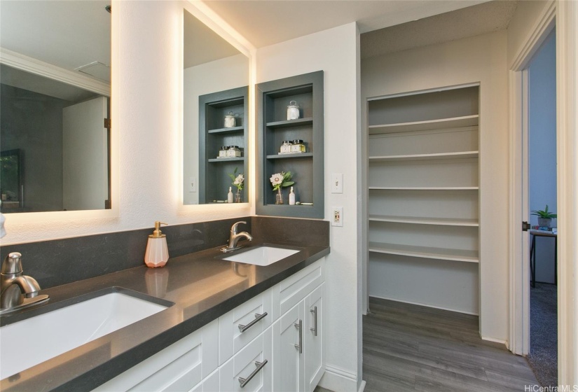 Bathroom vanity with a glimpse of the closet storage