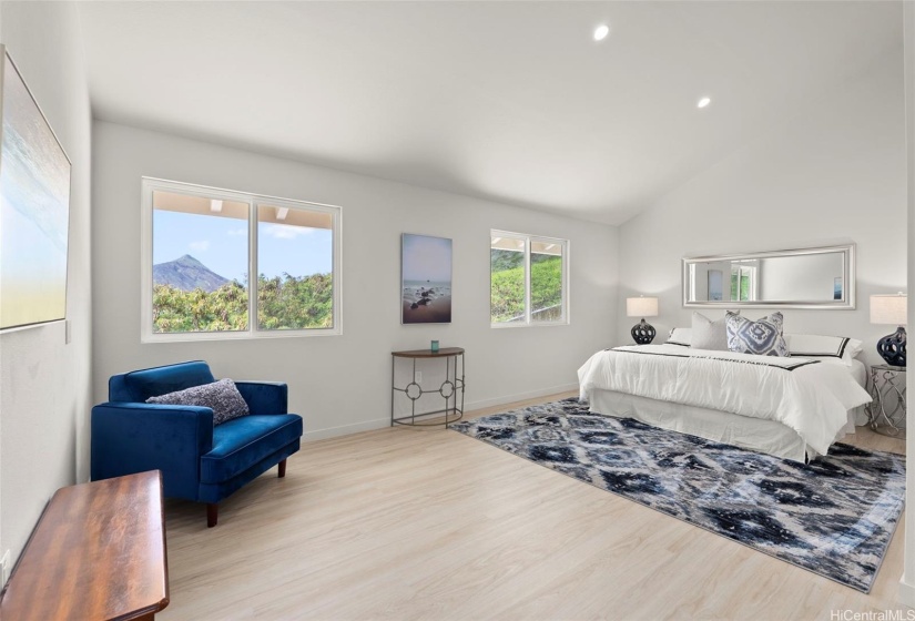 Front residence - inviting primary suite features soaring ceilings, Koko Head views, a spacious closet, and a luxurious spa-like ensuite bathroom.