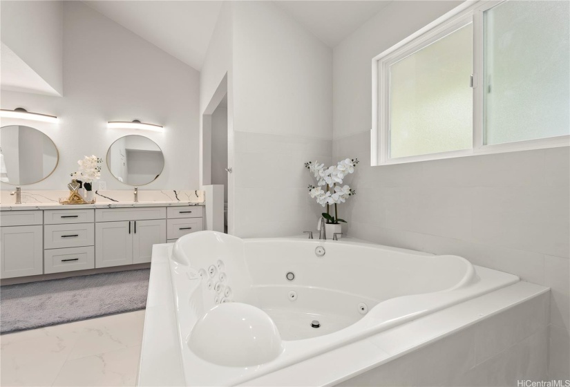 Front residence - luxurious primary en suite bathroom with Whirlpool tub, spacious shower, double vanity, and more.