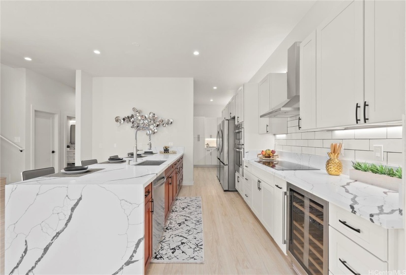 Front residence - kitchen boasts never-been used stainless steel appliances, including two large refrigerators, a convection microwave wall oven combo, induction stove, range hood, wine refrigerator, dishwasher and endless pantry space.