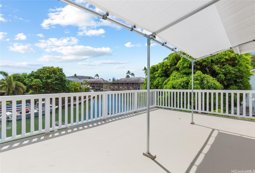 Step outside the primary bedroom into the large lanai on the 2nd floor.