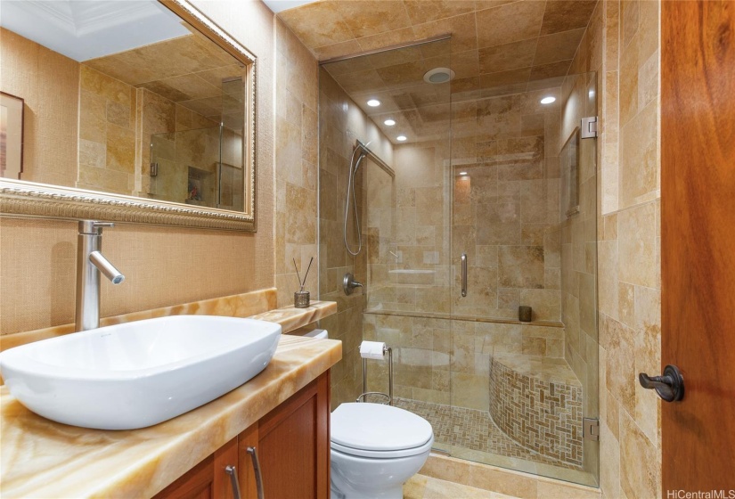 Highly upgraded 3rd bathroom with onyx counter top and travertine stone shower on the 1st floor.