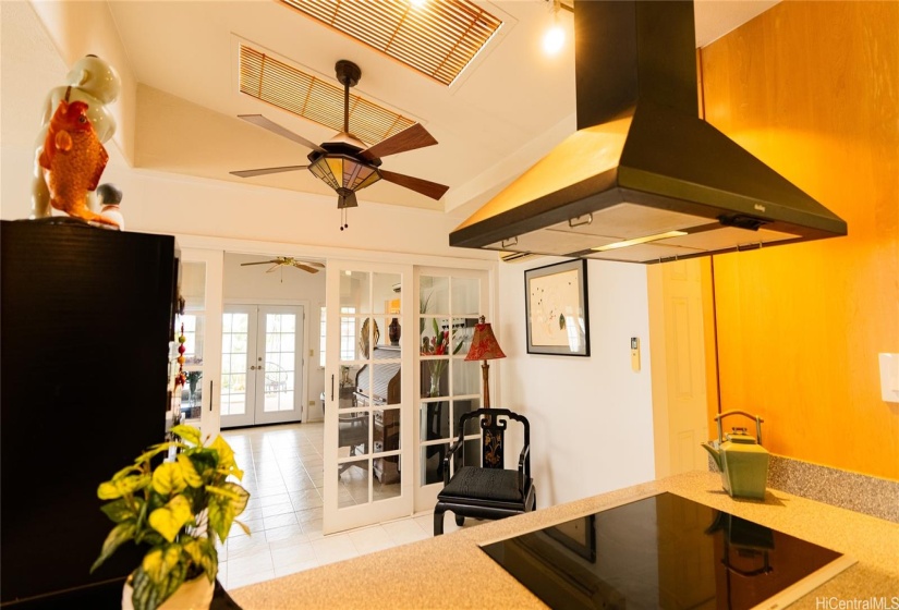 happy chef looking out to family room and patio and swing chair