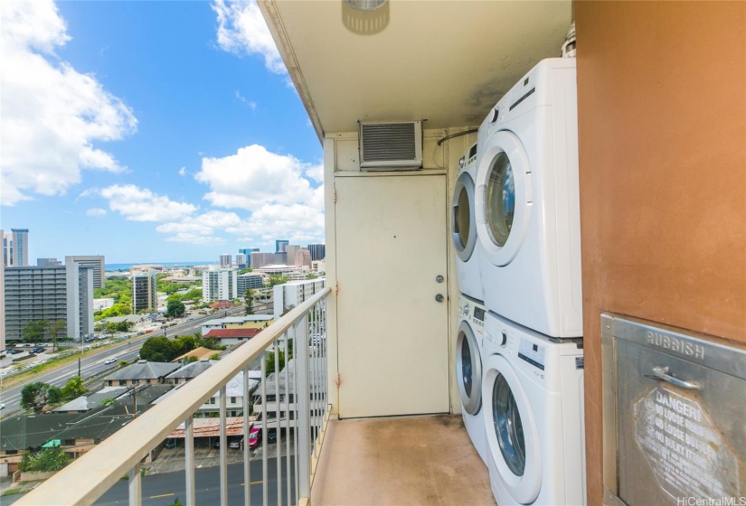 Full size washer and dryer with trash chute conveniently located.