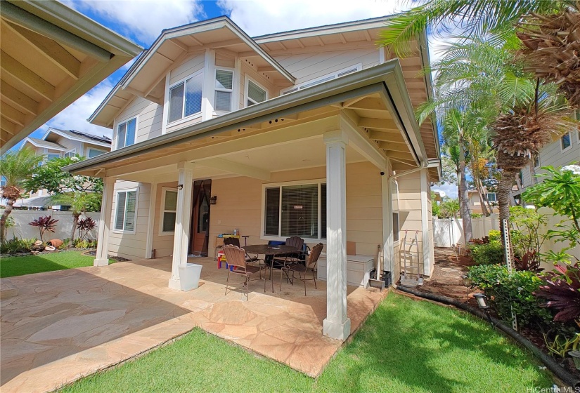 Outdoor seating area and nicely landscaped yard.