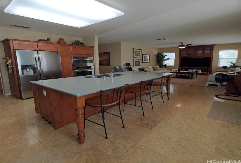 Generous kitchen island and open concept flow to the living room space.