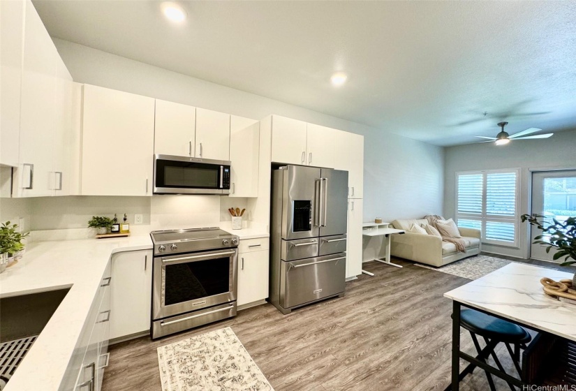 MODERN KITCHEN WITH STAINLESS STEEL APPLIANCES, AMPLE COUNTER & CABINET SPACE