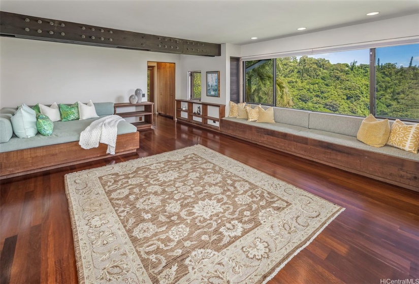 A comfortable daybed invites relaxation in the bedroom suite by the pool, with a bathroom and shower leading directly out.