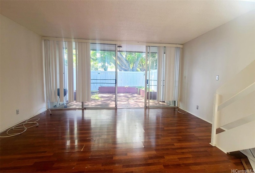 SPACIOUS LIVING ROOM WITH SLIDING DOORS THAT OPEN INTO A HUGE FENCED IN LOW MAINTENANCE YARD.