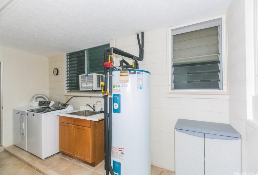 Indoor laundry, with laundry sink, heater, storage and folding area!