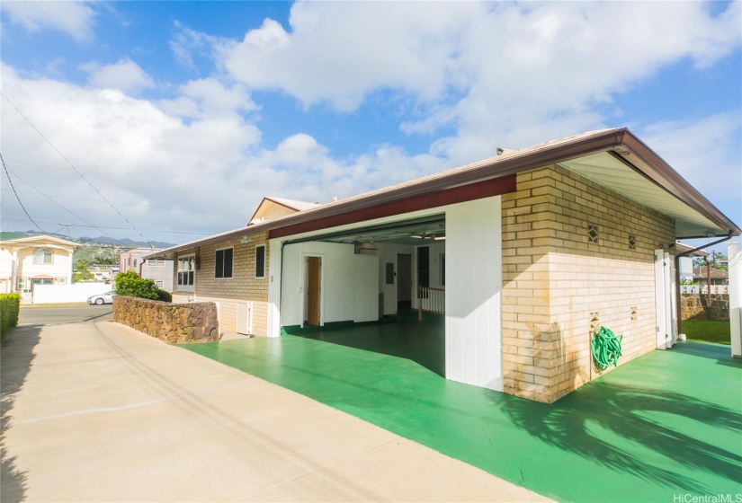 View from the automatic gated 2-car garage with additional parking/carwash area