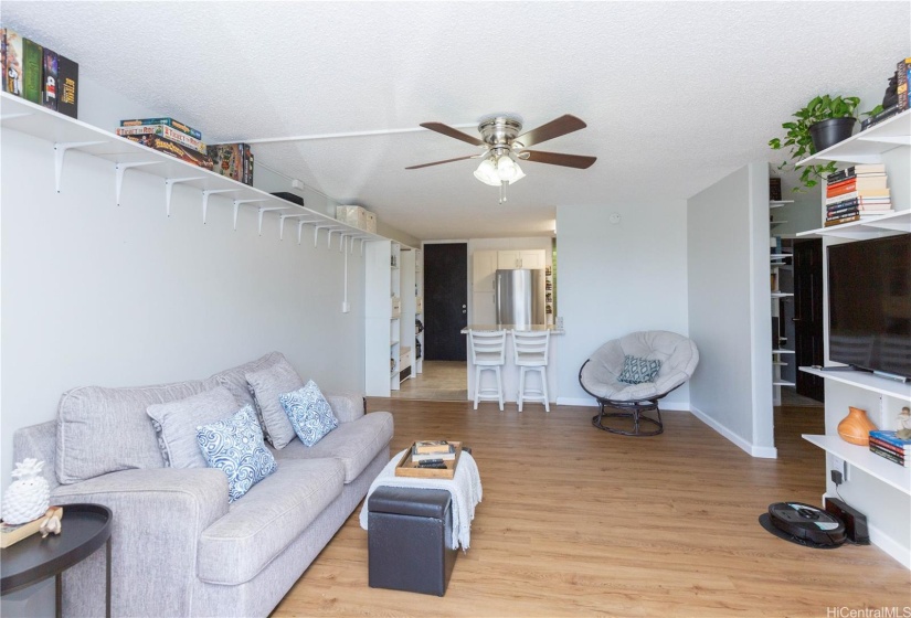 Spacious and open living area, with room for a small dining table and counter height bar stools.